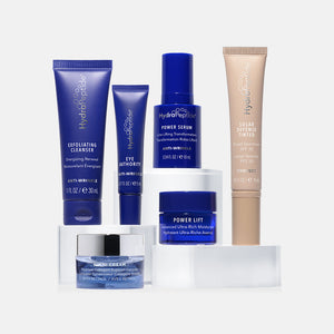 Collection of HydroPeptide skincare products including exfoliating cleanser, eye treatment, power serum, power lift moisturizer, and tinted solar defense, labeled Age Reversal Regimen | HydroPeptide.