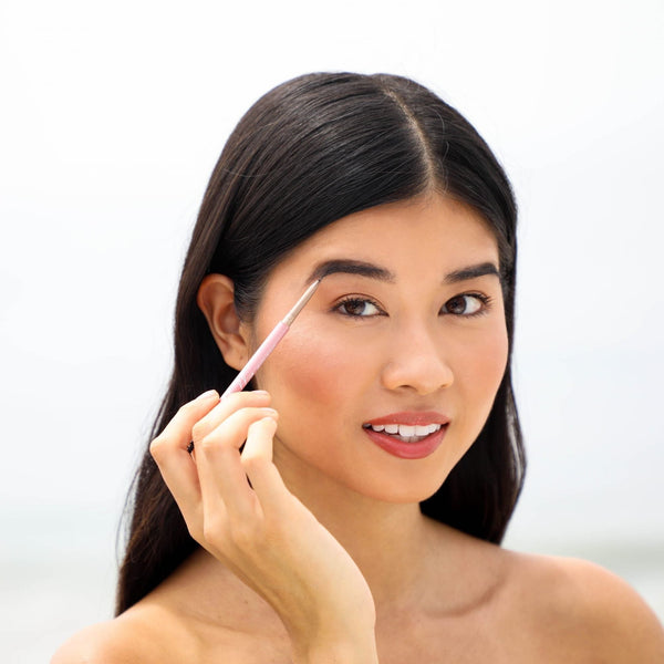 Young woman applying eyebrow makeup with Eyebrow Pencil | Chella, demonstrating precise grooming and enhancing natural beauty with a soft, natural look.