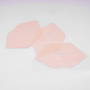 Three pink Hydrating Reusable Lip Mask | Dreambox Beauty patches displayed on a white background, shaped like lips for skincare and hydration purposes.