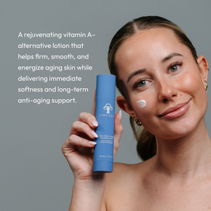 A woman with clear skin holds a blue bottle of Revita-Cyte Complex | Circadia lotion, applying a small amount of cream to her cheek, promoting skincare and anti-aging benefits.