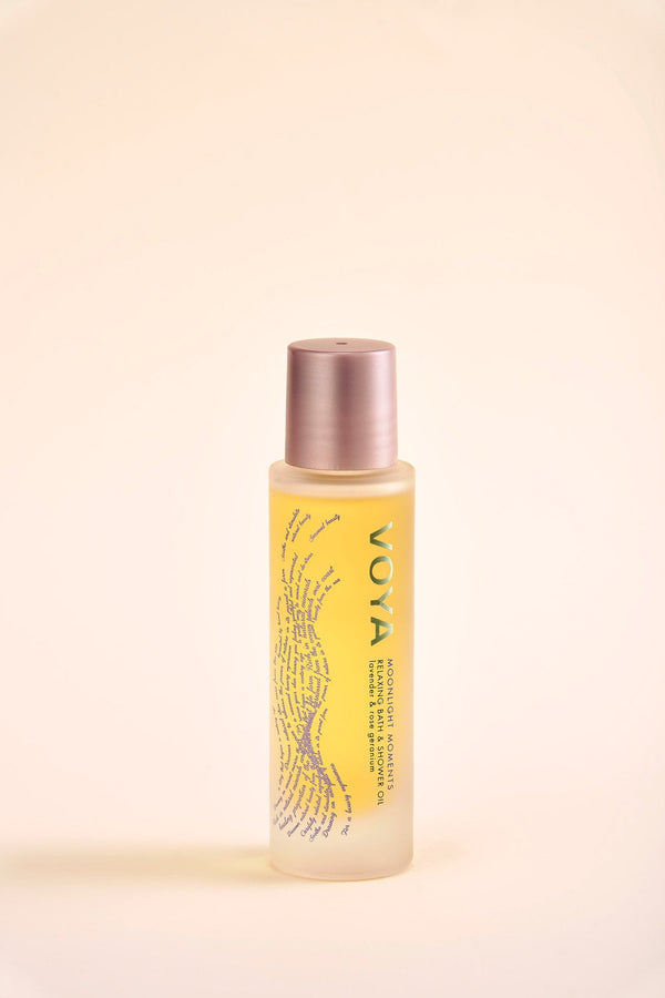 Bottle of Moonlight Moments Bath & Shower Oil | VOYA with golden-yellow oil inside, featuring a minimalist design and soft rose gold cap for skincare and body care wellness.