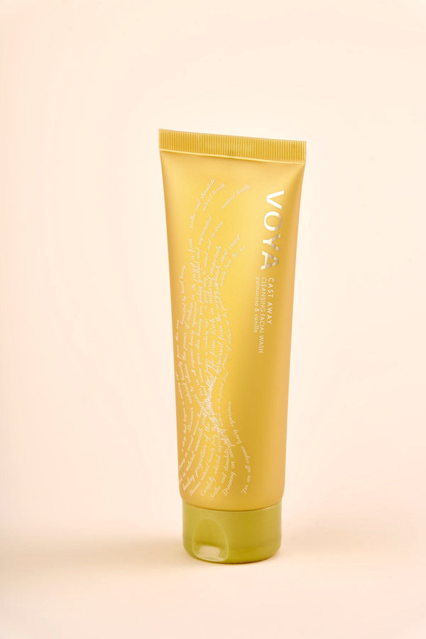 Yellow tube of Cast Away Cleansing Facial Wash | VOYA standing upright on a light background, featuring subtle white text and a green flip-top cap for skincare and wellness.