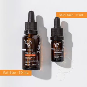 Two amber glass dropper bottles of Serum C20 | Yon-Ka Paris in 30 mL full size and 5 mL mini size with some serum drops next to them on a white background, highlighting anti-aging skincare.