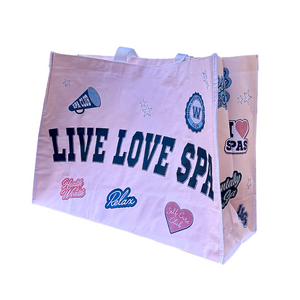Live Love Spa Collegiate Cuties Event Bag | Live Love Spa featuring a pink fabric tote with blue lettering and wellness-themed patches promoting relaxation, self-care, and spa love.