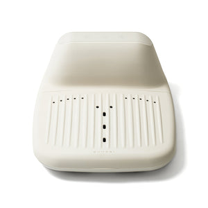 Modern ergonomic wellness device in off-white with ventilation holes designed for comfort and support, featuring the product name SUMSEI Air Shower | SUMSEI subtly embossed.