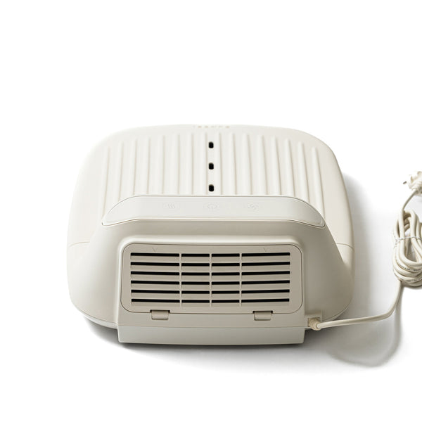 White compact air purifier device with vents and power cord designed for wellness use, featuring a sleek modern design, SUMSEI Air Shower | SUMSEI.