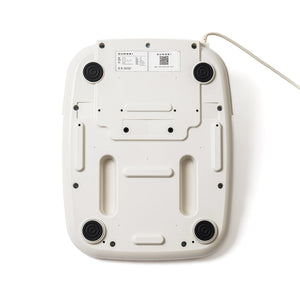Bottom view of the white SUMSEI Air Shower | SUMSEI wellness device showing four black rubber feet and attached power cord.