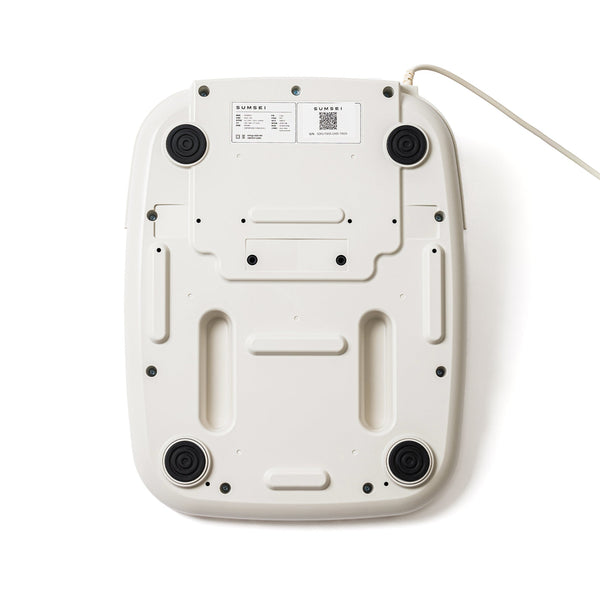 Bottom view of the white SUMSEI Air Shower | SUMSEI wellness device showing four black rubber feet and attached power cord.