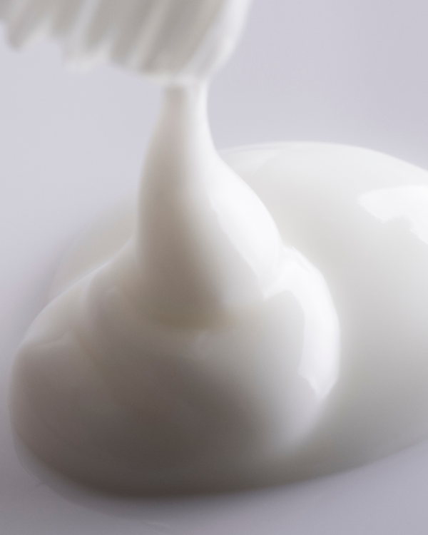 Close-up of smooth white serum texture being dispensed, representing the moisturizing and nourishing qualities of Replenish Ceramides + Blueberry Barrier Repair Serum | Three Ships skincare product.