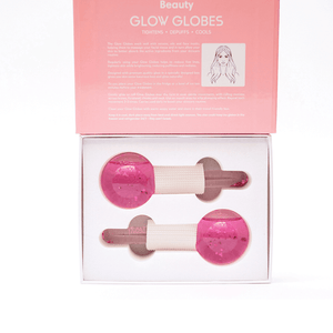 Glow Globes [Ice Roller for Face] | Dreambox Beauty features two pink facial rollers designed to tighten, depuff, and cool skin as part of a skincare routine.