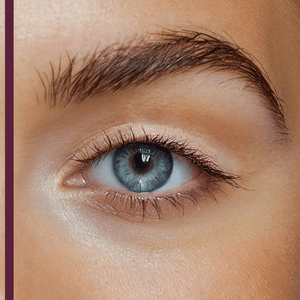 Close-up of a blue eye with natural eyelashes and well-groomed eyebrow, highlighting the effect of Curling TUBING™ Primer | Blinc for enhanced lash appearance.