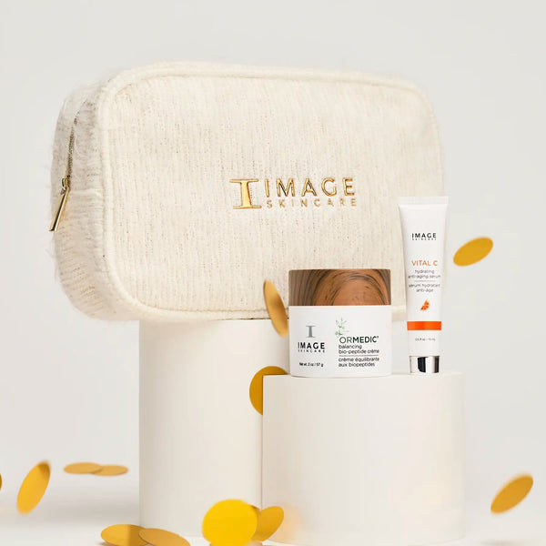 Dazzling Duo | IMAGE Skincare featuring a cream and serum with a textured cream cosmetic bag, displayed on white pedestals with gold confetti accents, showcasing skincare wellness.