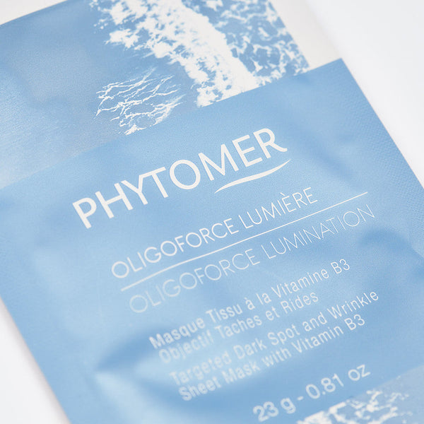 Close-up of the Oligoforce Lumination Targeted Dark Spot and Wrinkle Sheet Mask With Vitamin B3 - 4 Mask Set| Phytomer packaging, highlighting the skincare product details for targeted dark spots and wrinkles.