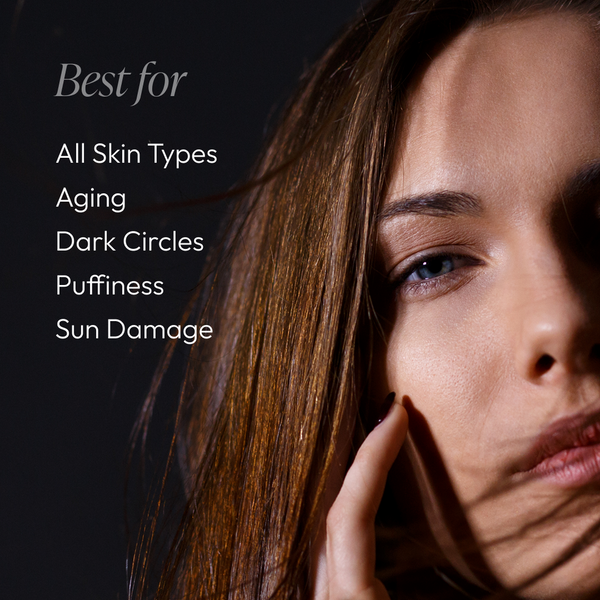 Close-up of a woman with clear skin touching her face, next to text listing benefits of Full Circle Eye Repair - Eye Cream Duo | Circadia for all skin types, aging, dark circles, puffiness, and sun damage.