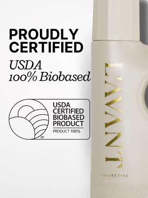 Partial view of a beige bottle with gold lettering showing the text "L'AVANT Collective" alongside a USDA Certified Biobased Product label and the words "Proudly Certified USDA 100% Biobased" promoting High Performing Laundry Detergent - Fresh Linen | L'AVANT Collective.