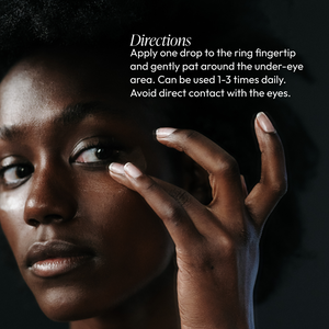Close-up of a person gently applying Eye Lift Serum (formerly Emergency Eye Lift) | Circadia under their eye with the ring fingertip, demonstrating skincare application directions.