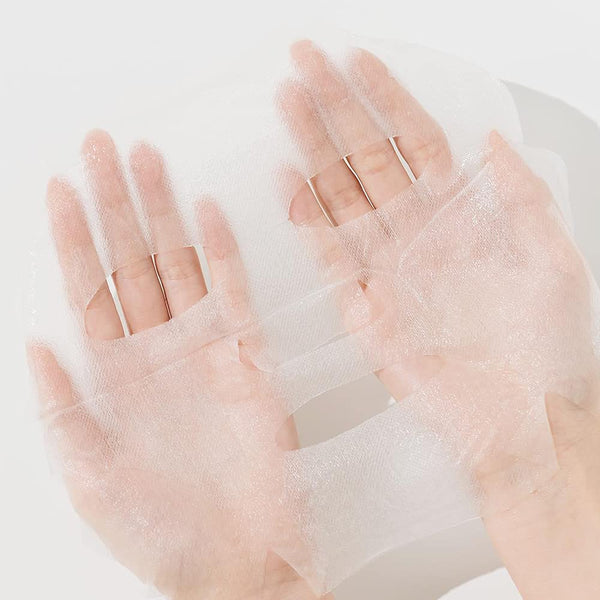 Hands holding a delicate, translucent skincare sheet mask designed for facial treatment with ImPHYTO AHA | Leaders for enhanced skincare and wellness.