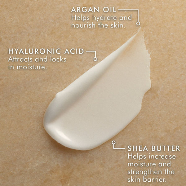 Close-up of a creamy textured skincare product highlighting key ingredients: argan oil for hydration, hyaluronic acid for moisture retention, and shea butter to enhance skin moisture and strength, featuring Hand Cream | Moroccanoil.