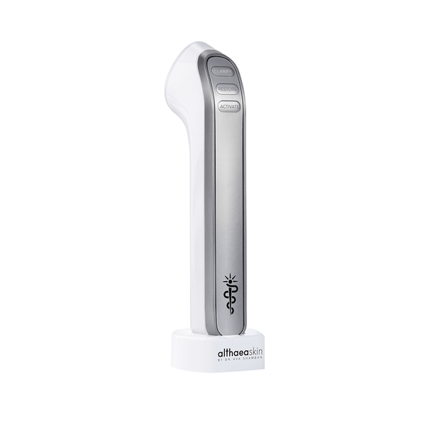 C·A·R·A Multi-Modal Tool Kit | Althaea Skin device in white and silver with buttons labeled Clear, Restore, and Activate, standing on a branded base for skincare and wellness use.