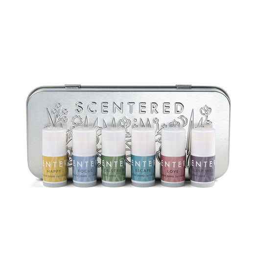 Metal tin containing six aromatherapy balm sticks in various colors, designed for wellness and relaxation with the Wellbeing Ritual Aromatherapy Mini Tin | Scentered.