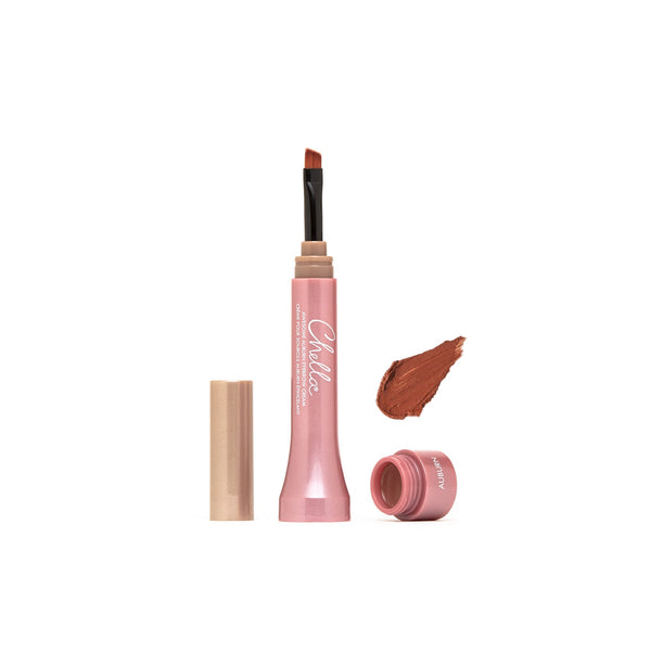 Open tube of Eyebrow Cream | Chella with angled applicator brush and swatch of auburn cream color on white background, showcasing creamy texture for precise brow definition.