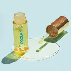 Classic Liplux® Organic Hydrating Lip Oil Sunscreen SPF 30 with golden hydrating oil and applicator dropper on a light blue background, showcasing skincare and sun protection benefits.