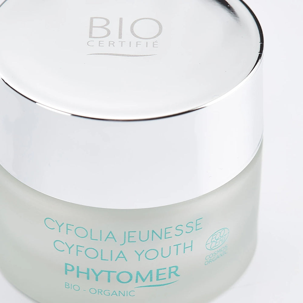 Jar of Cyfolia Youth Glow Renewing Wrinkle Cream | Phytomer in frosted glass with silver lid, featuring organic skincare designed for youthful skin glow.