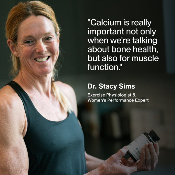 Woman holding a bottle of Calcium supplements smiling, with quote from Dr. Stacy Sims about Calcium’s importance for bone health and muscle function.