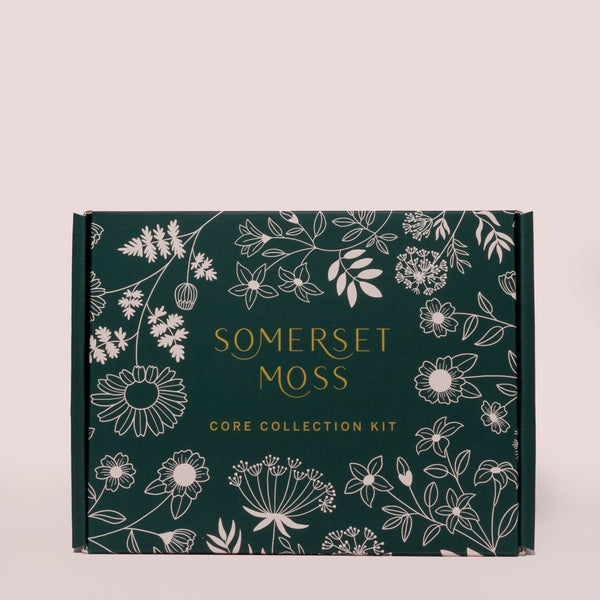 Core Collection Kit | Somerset Moss box with botanical floral illustrations in white on a dark green background, showcasing a skincare and wellness packaging design.