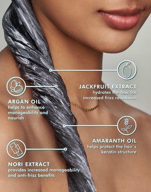Close-up of a woman with conditioner applied to her hair, highlighting ingredients jackfruit extract, argan oil, amaranth oil, and nori extract with benefits explained, promoting Frizz Control Conditioner | Moroccanoil.