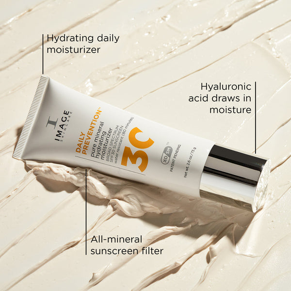 Tube of DAILY PREVENTION Pure Mineral Hydrating Moisturizer SPF 30 | IMAGE Skincare on creamy textured surface, highlighting hydrating daily moisturizer, hyaluronic acid, and all-mineral sunscreen filter.