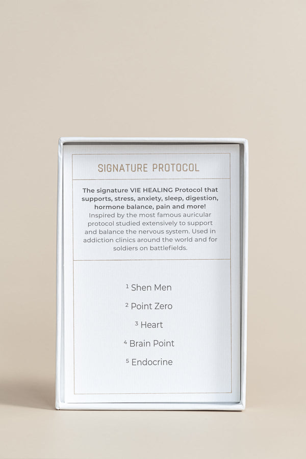 The Foundation - 24K Gold Ear Seed | Vie Healing packaging showing the Signature Protocol details that support stress, anxiety, sleep, digestion, hormone balance, and pain relief.