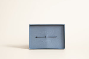 Calm Cool Collected - 24K Gold Ear Seed | Vie Healing displayed in a minimalist blue box with a small metal tool on a neutral background, highlighting wellness and recovery tools.