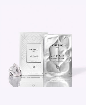 Diamond Radiance Collagen Lip Mask | KNESKO skincare product packaging with a silver foil packet and matching box, shown with a small crystal for a radiant wellness theme.