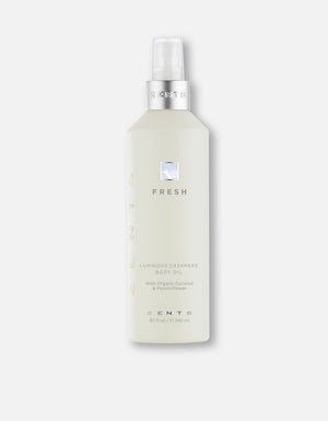 Bottle of Body Oil | Zents with a sleek frosted design and silver pump, featuring a fresh, luminous cashmere formula for skincare and body care.