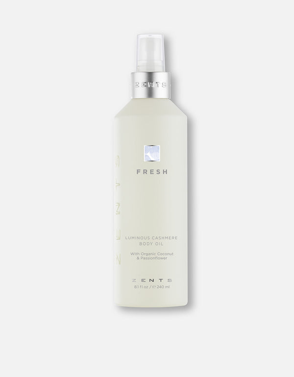 Bottle of Body Oil | Zents with a sleek frosted design and silver pump, featuring a fresh, luminous cashmere formula for skincare and body care.