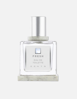 Clear glass bottle of Eau de Toilette | Zents with silver cap and minimalist label reading Fresh, designed for a clean and crisp fragrance experience.