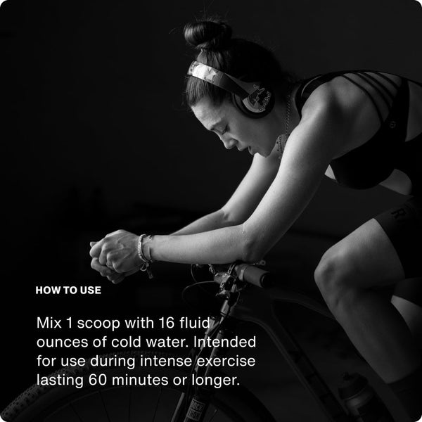 Woman wearing headphones intensely cycling indoors with instructions on how to use Fuel for hydration and endurance during long exercise sessions