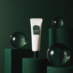 White tube of Green Collagen Eye Cream for Face | Leaders displayed on dark green geometric pedestals with reflective glass spheres, highlighting skincare and wellness.