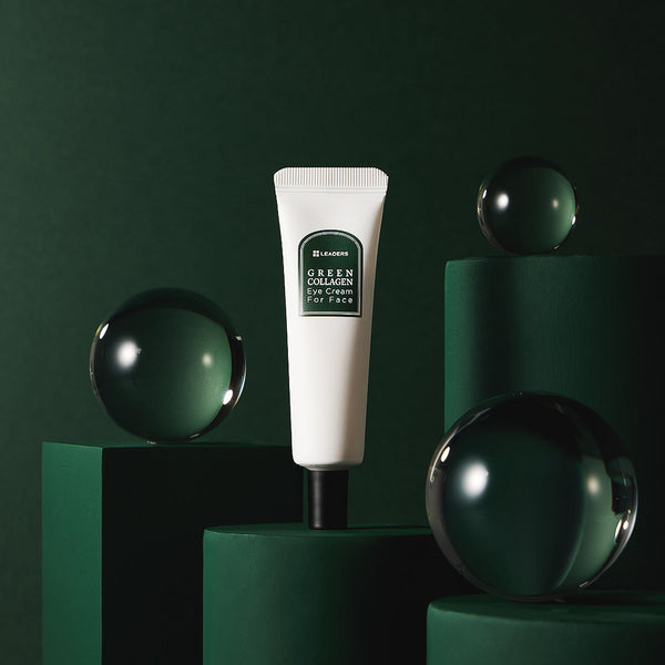 White tube of Green Collagen Eye Cream for Face | Leaders displayed on dark green geometric pedestals with reflective glass spheres, highlighting skincare and wellness.