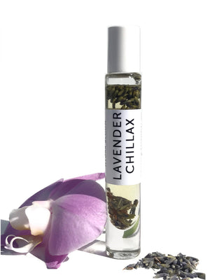 Lavender Chillax Organic Perfume Roll-on | Hydra Bloom in a clear glass bottle with lavender buds inside, displayed alongside a purple flower and dried lavender petals for wellness and skincare.