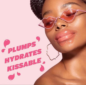Close-up of a woman wearing a hydrating reusable lip mask from Dreambox Beauty, styled with pink lip-shaped sunglasses and hoop earrings, promoting plump, hydrated, kissable lips.