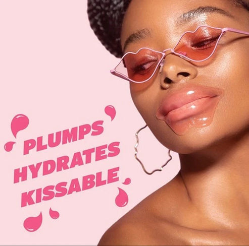 Close-up of a woman wearing a hydrating reusable lip mask from Dreambox Beauty, styled with pink lip-shaped sunglasses and hoop earrings, promoting plump, hydrated, kissable lips.