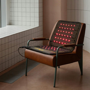 Jet Chair - PEMF Far Infrared Heating Mat | HealthyLine displayed on a modern brown leather chair with glowing red infrared heating elements for enhanced wellness and recovery.