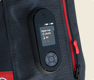Close-up of the control panel on the JetBoots PRO Plus | Therabody, showing an active recovery session set to upper leg mode with temperature and time settings on a textured black fabric background.