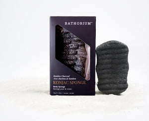Konjac Bamboo Charcoal Body Sponge | Bathorium beside its product box, showing a black textured sponge and packaging on a white background for body care.