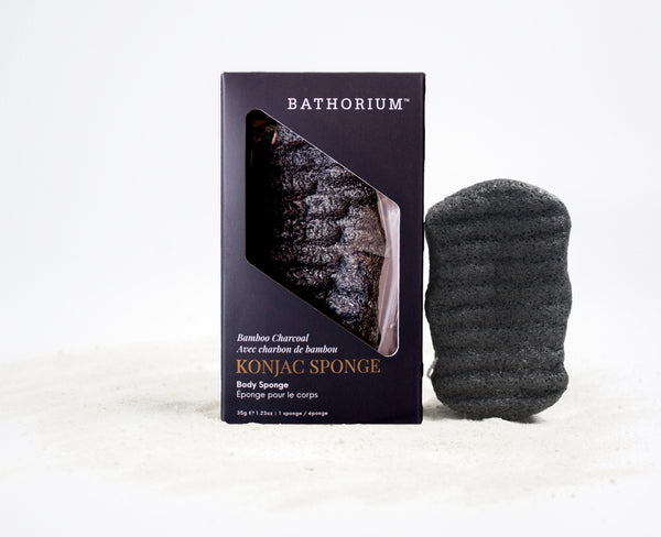 Konjac Bamboo Charcoal Body Sponge | Bathorium beside its product box, showing a black textured sponge and packaging on a white background for body care.
