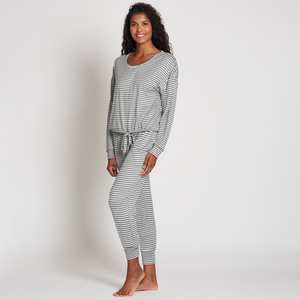 Woman wearing a striped comfortable lounge outfit standing barefoot against a plain background, showcasing the Jogger Sleep Set - 2PC | Lemon.