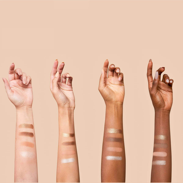 Four arms of different skin tones display swatches of neutral shades from the La Vie Neutral Eyeshadow Palette | Chella against a beige background.