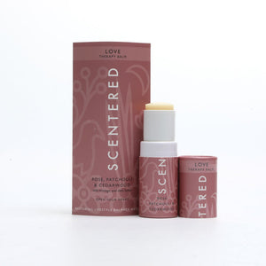 Love Therapy Balm | Scentered in a pink tube and matching box with rose, patchouli, and cedarwood, designed for skincare and wellness use.